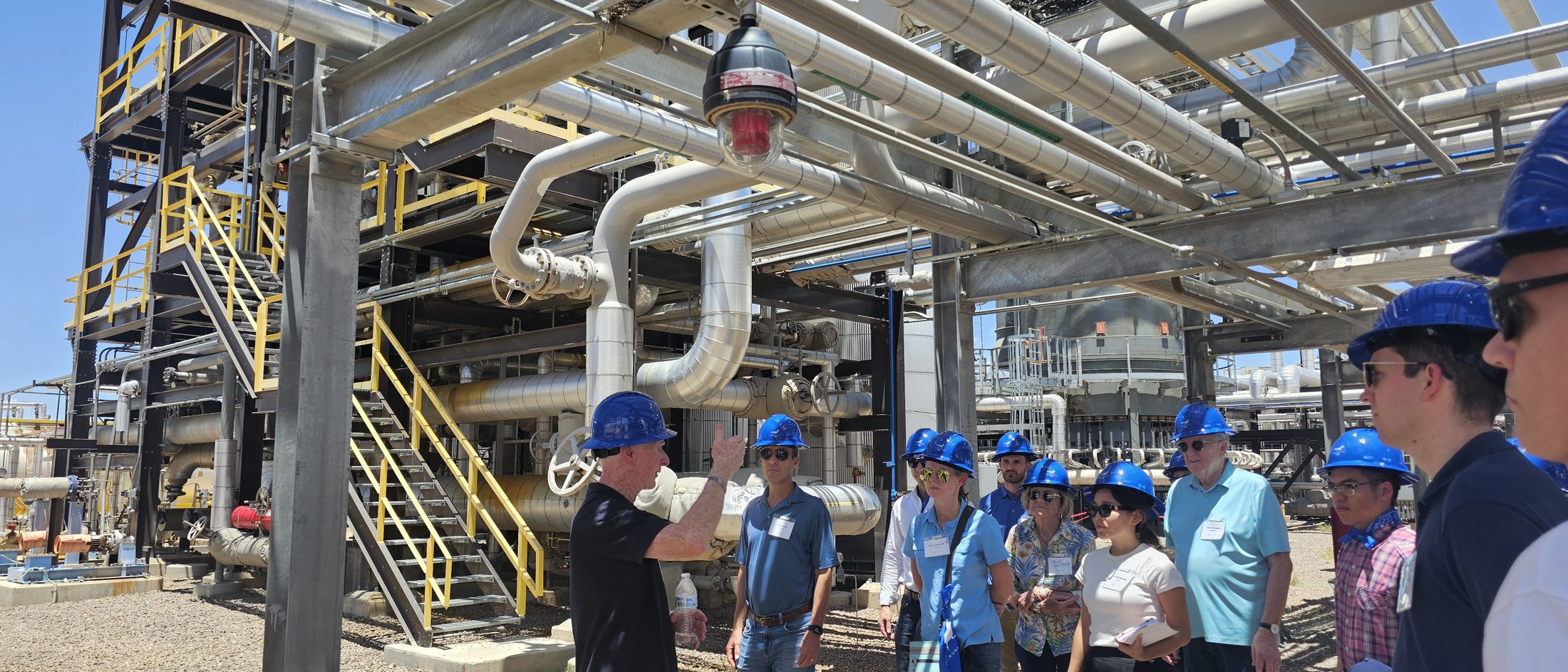 Infinium engineers walking visitors through the process racks at a West Texas eFuels facility